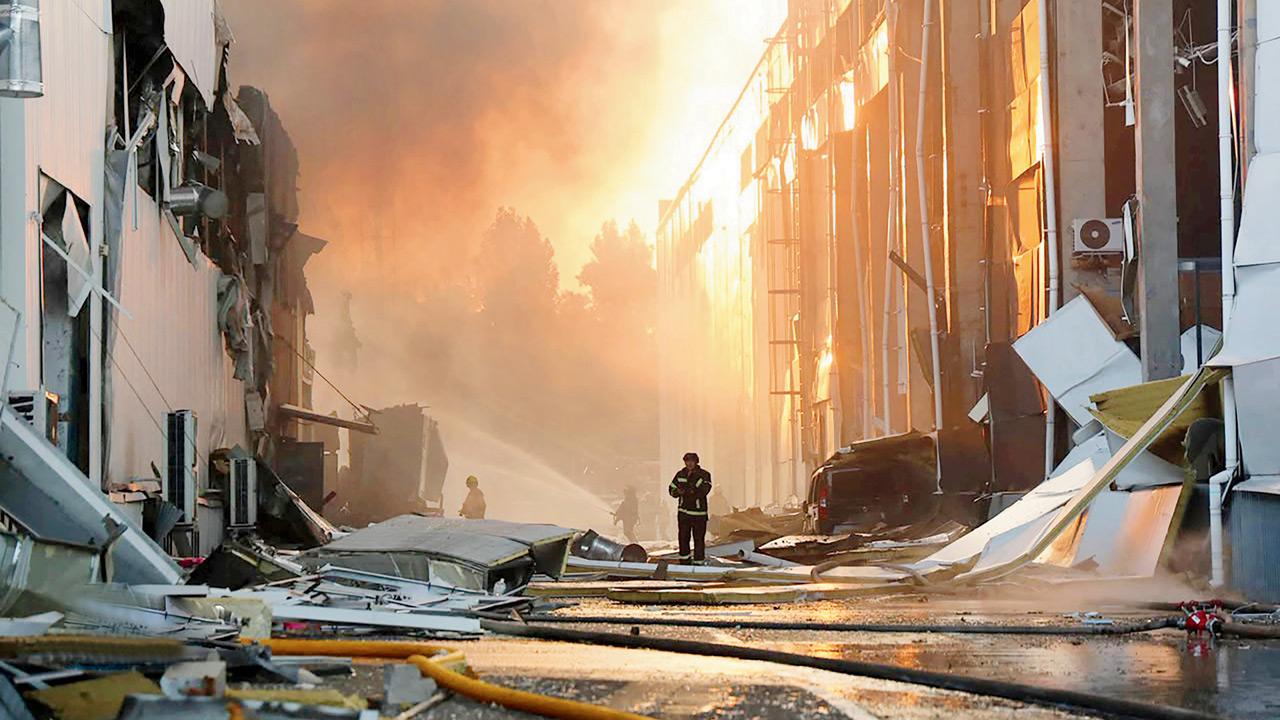 Ukrainian firefighters work to extinguish a blaze at the site of a Russian air attack in Kyiv. PIC/AFP