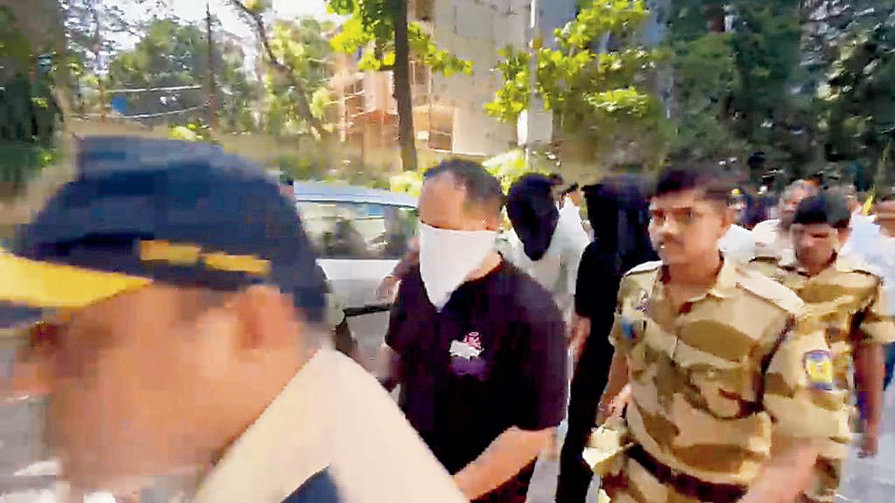 Accused Vineet Gerelani (with face covered) in whose house 15 Ecstasy pills were allegedly found. File Pics