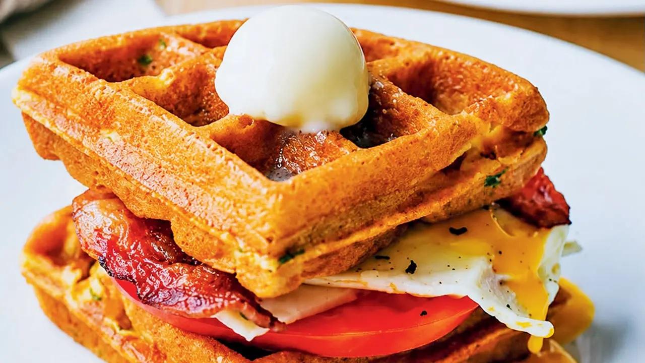 Sugar rushSweet waffles can wait. This Ham and Cheese Waffle Sandwich packs crispy bacon, tomatoes, a fried egg, and a generous drizzle of cheese sauce into the perfect brunch snack. (Pic courtesy/Out of the Blue)
At Out of the Blue, Union Park Road Number 4, Khar.Call 9930530510Cost Rs 499