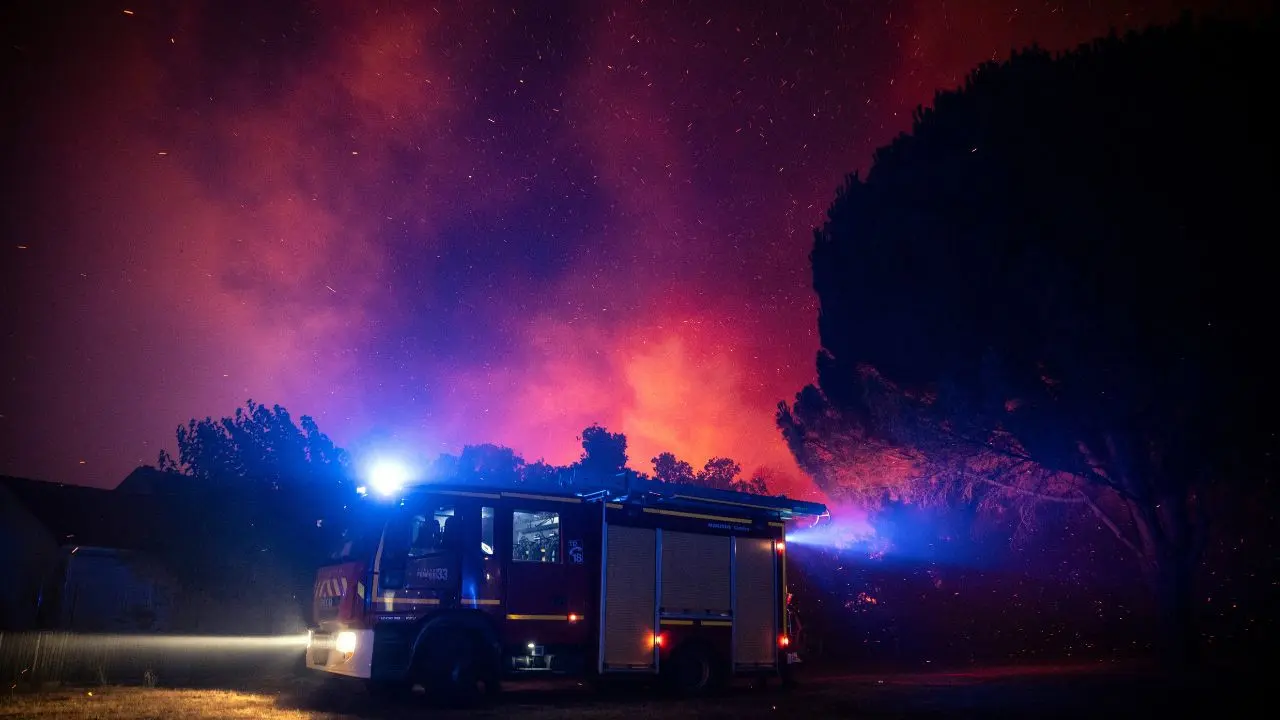 IN PHOTOS: Wildfire burns southern Europe as Spain declares national emergency Firefighters move in a fire truck as a forest burns close to a residential area during a wildfire near Lege-Cap-Ferret, southwestern France, on Friday. PIC/AFP
