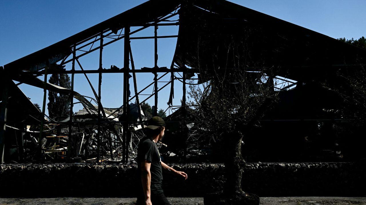Firefighters in France and Spain raced to contain some of the worst wildfires in living memory on Tuesday as another heatwave threatened to intensify the crisis. The blazes have scorched vast forest areas, destroyed properties and forced tens of thousands to evacuate. In the picture, a man walks past a plant nursery destroyed by a wildfire in a business park in Biscarrosse, southwestern France