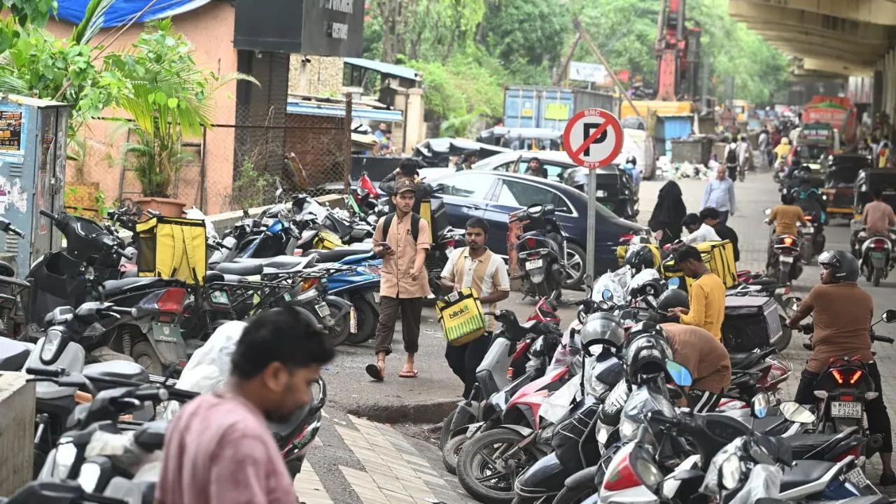 IN PHOTOS: Mumbai's Blinkit delivery partners park vehicles in no parking zone Several two-wheelers were lined up outside the commercial complex. (Pics/ Satej Shinde)