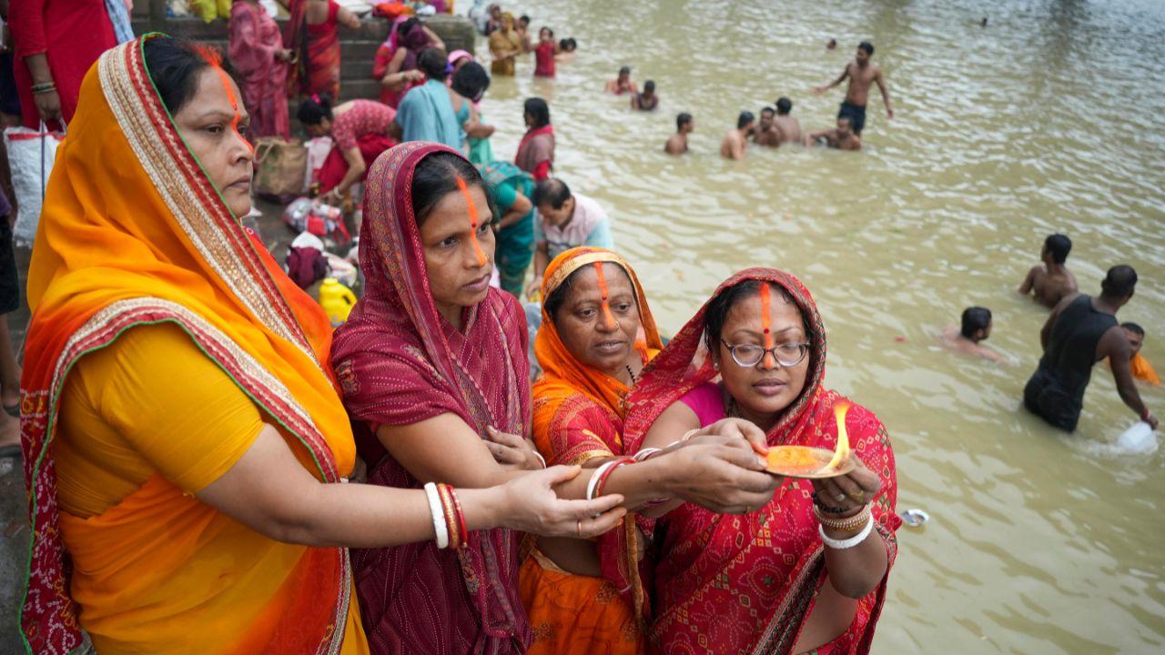 Pilgrims offer prayers and perform rituals on the banks of the Saryu River on the auspicious occasion of Guru Purnima