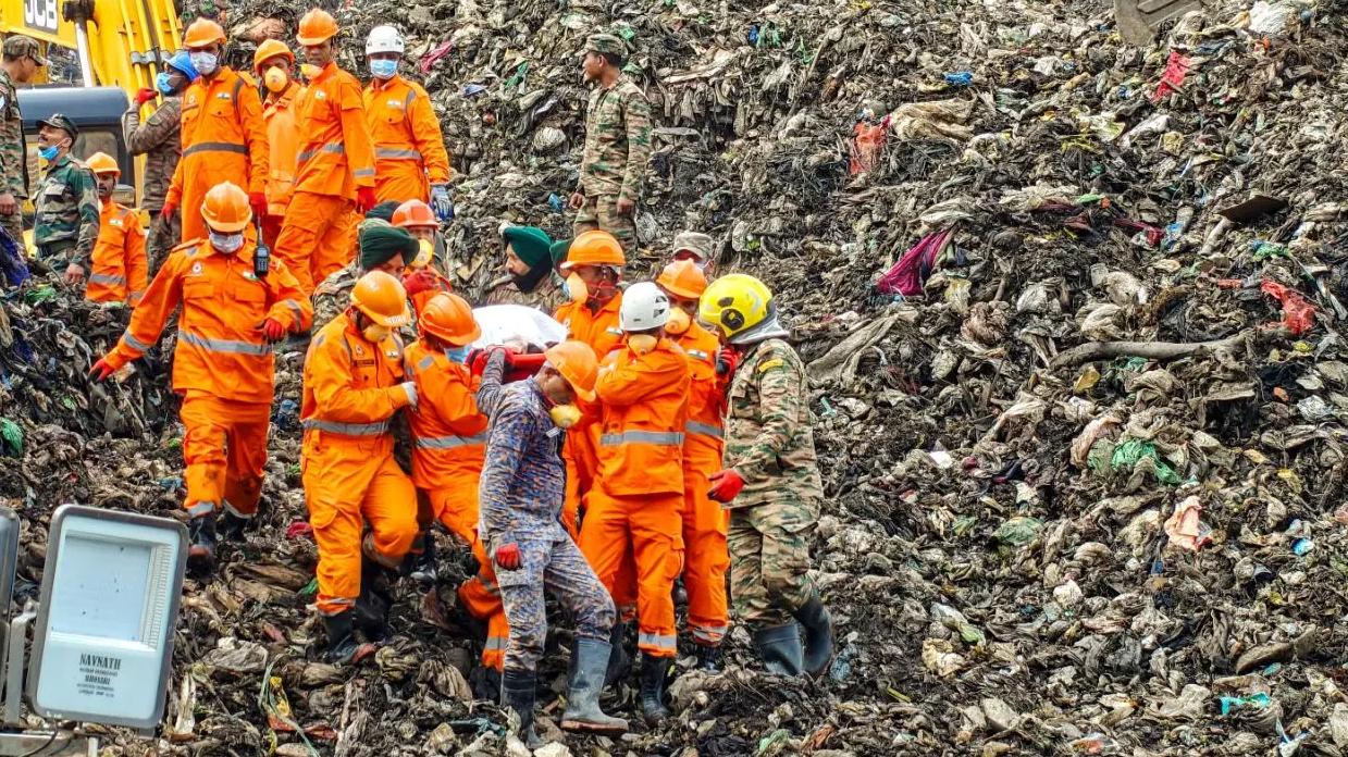 Rescue teams recover a body from the collapsed building at the Moshi waste-to-energy plant in Pune