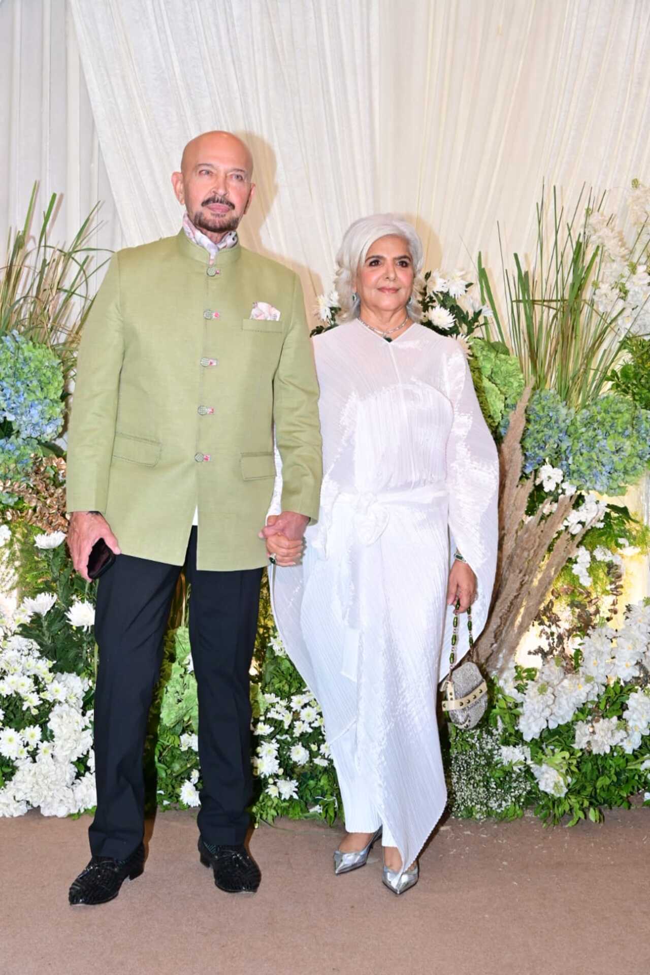 Rakesh Roshan and his wife arrive in pastel and white shades for the wedding reception. Rakesh Roshan keeps it simple yet stylish with his outfit