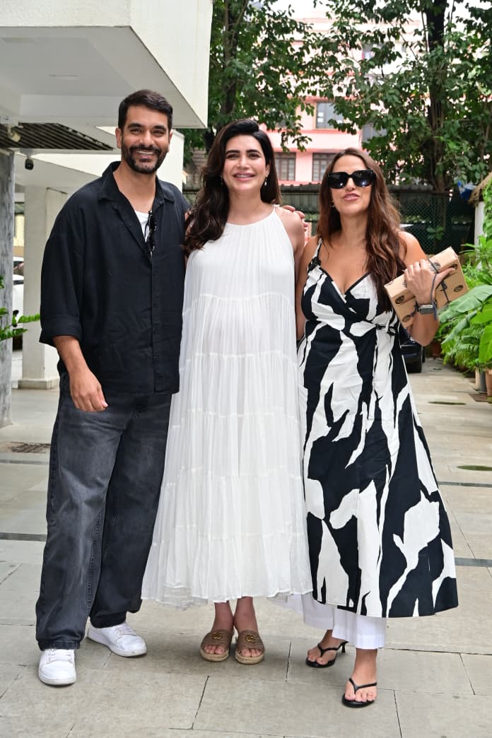 Karishma Tanna spotted flaunting her baby bump in a white gown as she poses with Neha Dhupia and Angad Bedi. We wonder what their upcoming episode will be about