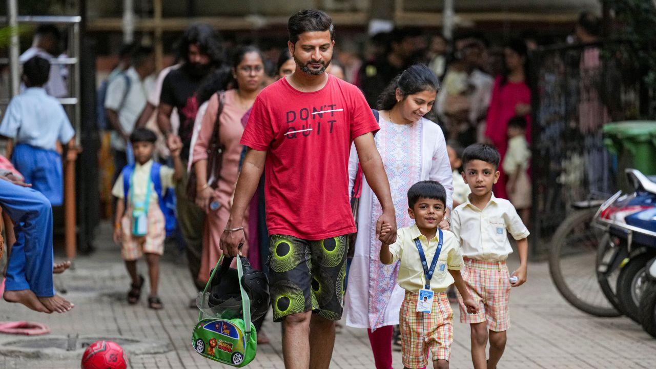 IN PHOTOS: Tiny tots receive warm welcome as Mumbai schools reopen A young student fights back tears as he enters the premises of Sane Guruji English Medium High School on Day 1 of reopening