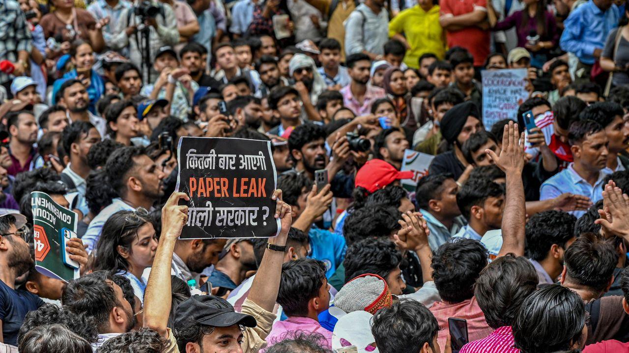 Protestors raise slogans and hold flowers during the Cockroach Janta Party's protest in Delhi, demanding justice for students affected by the alleged NEET-UG paper leak Protestors raise slogans and hold flowers during the Cockroach Janta Party's protest in Delhi, demanding justice for students affected by the alleged NEET-UG paper leak