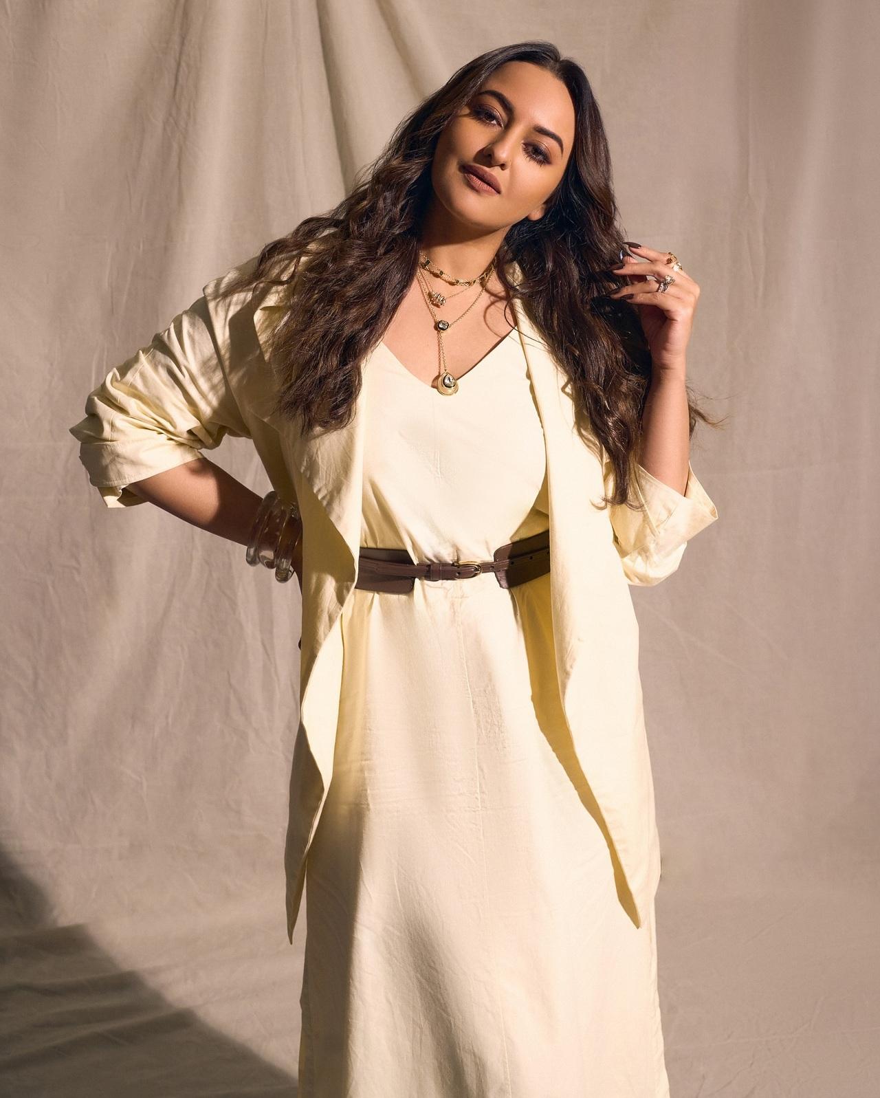 Sonakshi embraces a soft, sophisticated aesthetic in an ivory dress layered with a matching jacket. The belted waist and delicate jewellery add a touch of grace. Sonakshi embraces a soft, sophisticated aesthetic in an ivory dress layered with a matching jacket. The belted waist and delicate jewellery add a touch of grace.