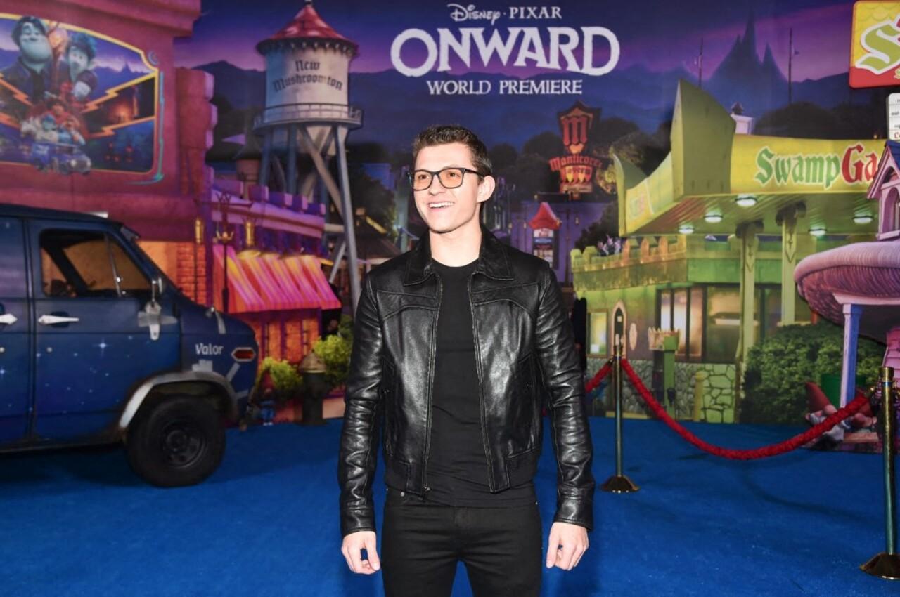 Tom Holland effortlessly nails a cool, casual look by rocking a sleek black leather jacket over a simple black t-shirt and matching slim-fit trousers.