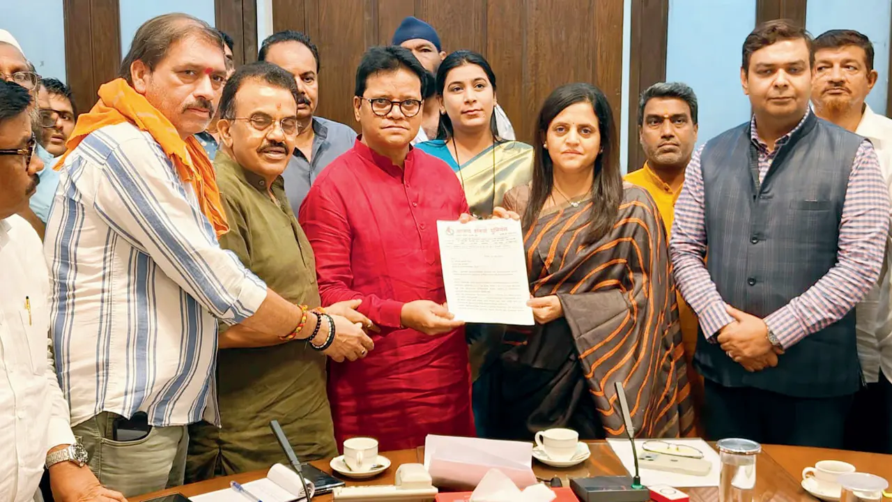 A Shiv Sena (UBT) delegation with BMC chief Ashwini Bhide (in striped saree). PIC/X/@misanjayghadi