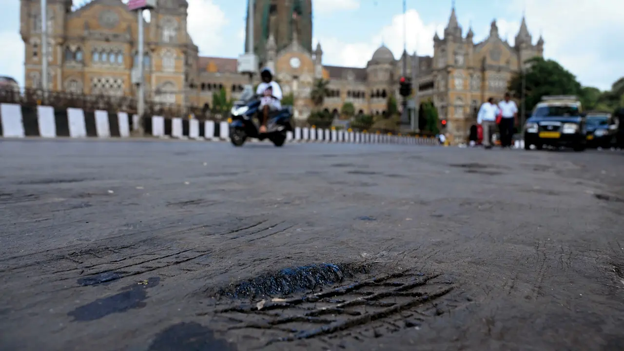 Extreme heat softens the road surface outside the BMC headquarters in Fort, leaving visible tyre impressions on the tar. Pic/Ashish Raje