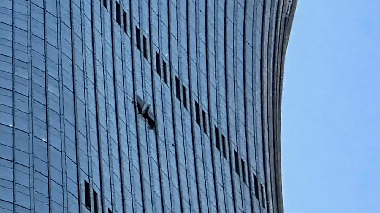 A hole is seen (right) on the side of the CITIC Tower in Beijing on Friday, after an eyewitness reported plane debris at the base of Beijing's tallest building. PIC/AFP