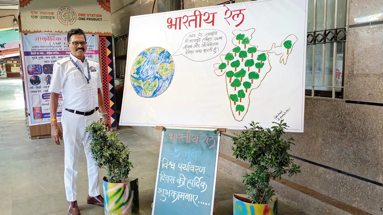 Reay Road station manager Vinayak Shewale poses beside an Environment Day awareness display at the station during a special sustainability drive organised by Central Railway.  Pic/Central Railway