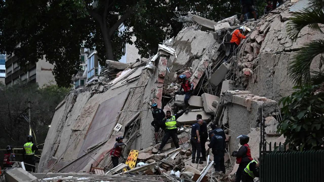 Rescuers search for and evacuate survivors from the rubble of a collapsed building in Caracas following twin earthquakes that rocked Venezuela on wednesday