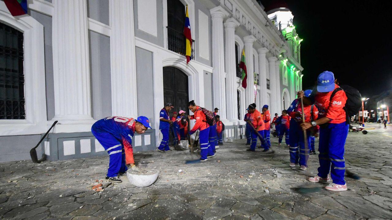 Valencia municipal workers clear the site of a damaged building following an earthquake in Valencia