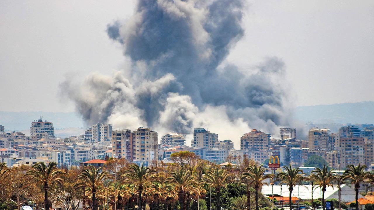 Israel orders strikes on Beirut suburbs, cites Hezbollah ceasefire violations A plume of smoke rises following an Israeli airstrike on the outskirts of Tyre, southern Lebanon, on Monday. PIC/AFP