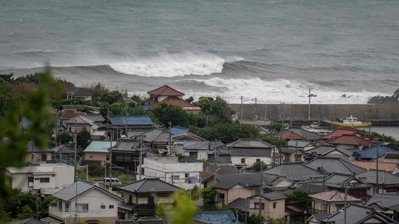 Storm Jangmi -- which was downgraded from a typhoon -- injured 15 people in southern Japan on Tuesday, knocked out power to thousands of homes and grounded hundreds of flights.