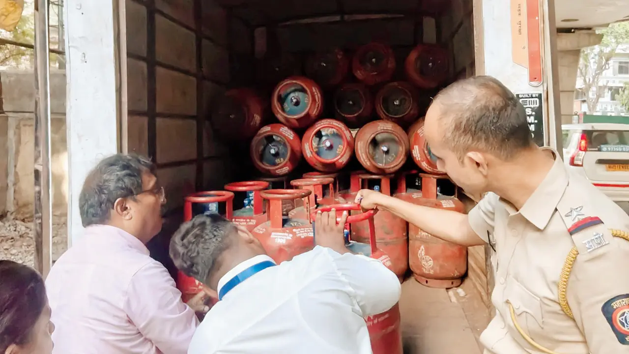 Khar police bust illegal LPG refilling racket, 40 cylinders seized The accused was using a metal pipe to transfer gas. Pic/By Special Arrangement