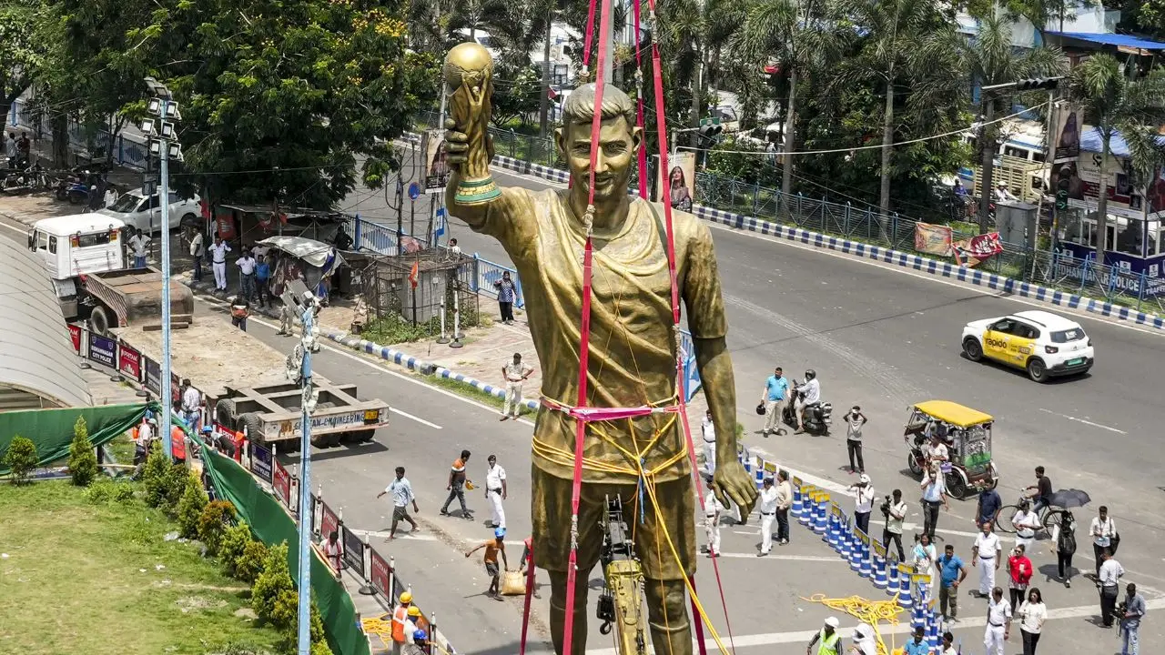PWD workers shift a statue of Argentine footballer Lionel Messi on a trailer, in Kolkata, on Monday. PIC/PTI PWD workers shift a statue of Argentine footballer Lionel Messi on a trailer, in Kolkata, on Monday. PIC/PTI