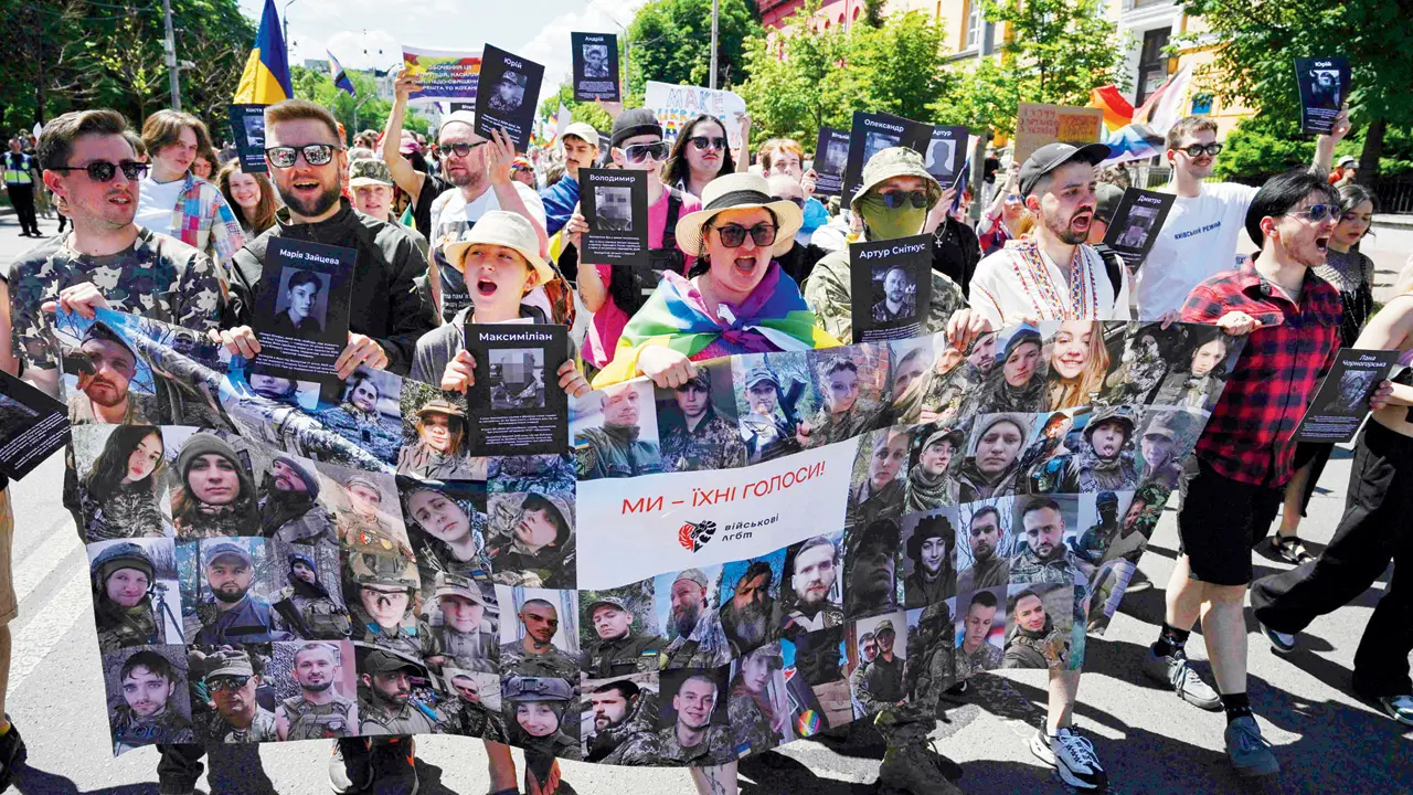 Russia shoots down 301 drones overnight, says defence ministry Demonstrators in Kyiv hold a banner with portraits of army service members part of the LGTQ community. PIC/AFP