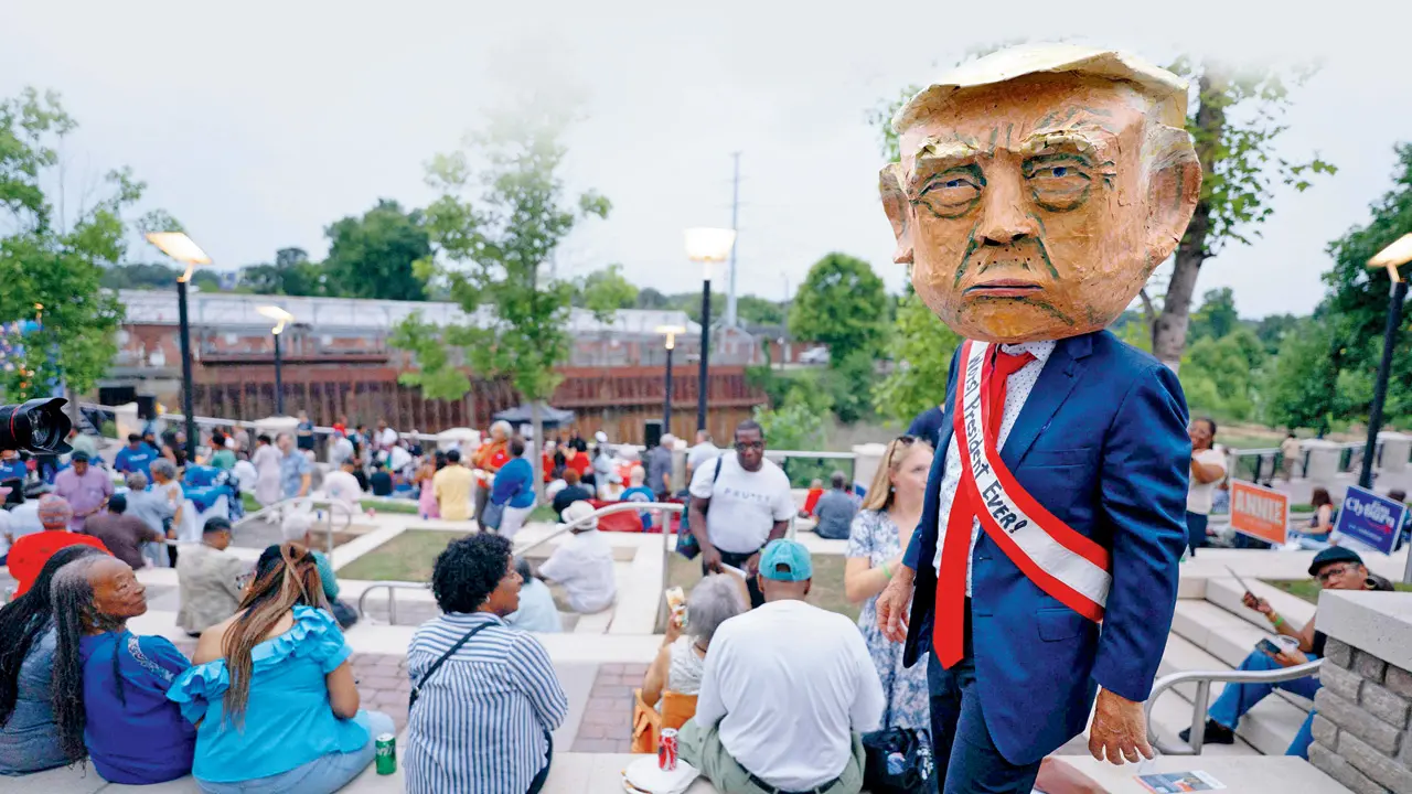 A person wearing a mask in the likeness of US President Donald Trump walks through Rep Jim Clyburn’s annual ‘World Famous Fish Fry’ at Edventure Children’s Museum in Columbia, South Carolina. PIC/AFP