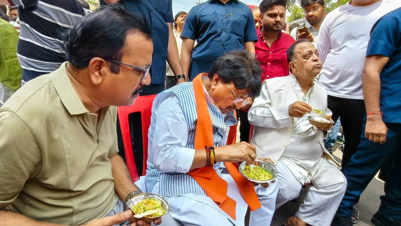 Madhya Pradesh Cabinet Minister Kailash Vijayvargiya joins in the celebrations to eat poha during a celebration marking World Poha Day in Indore