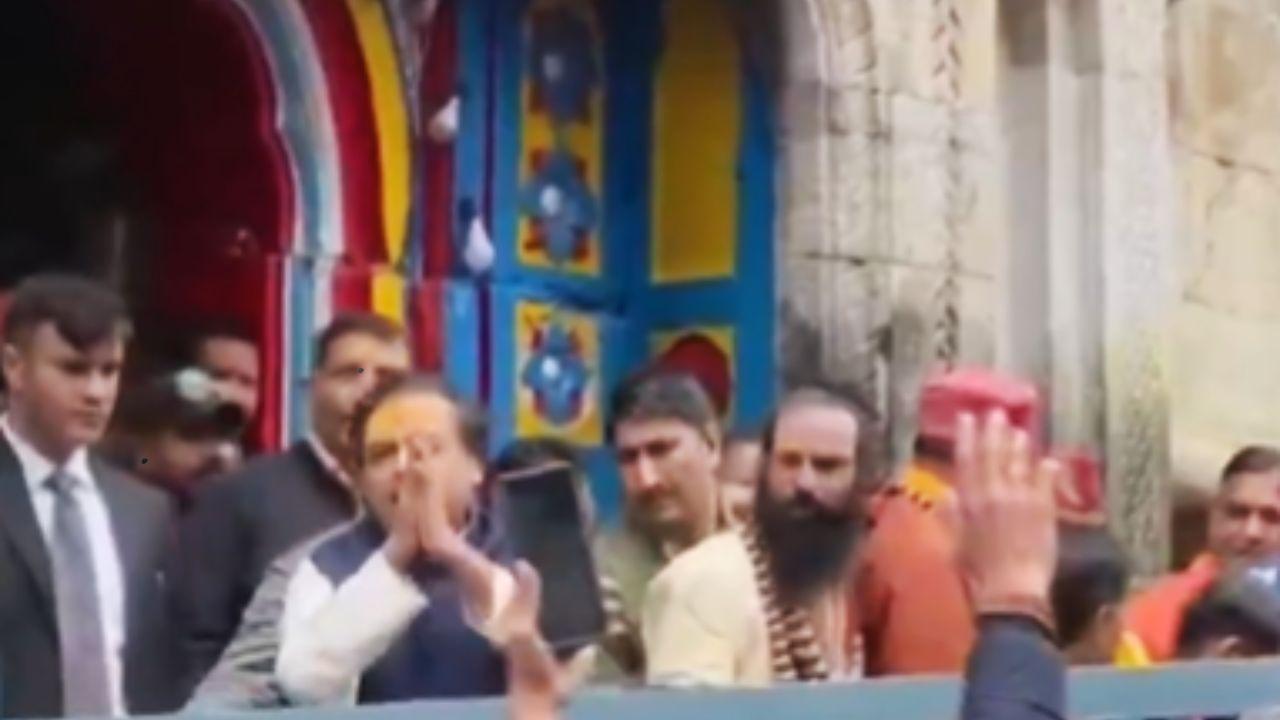 The business tycoon waved at the devotees present at the temples The business tycoon waved at the devotees present at the temples