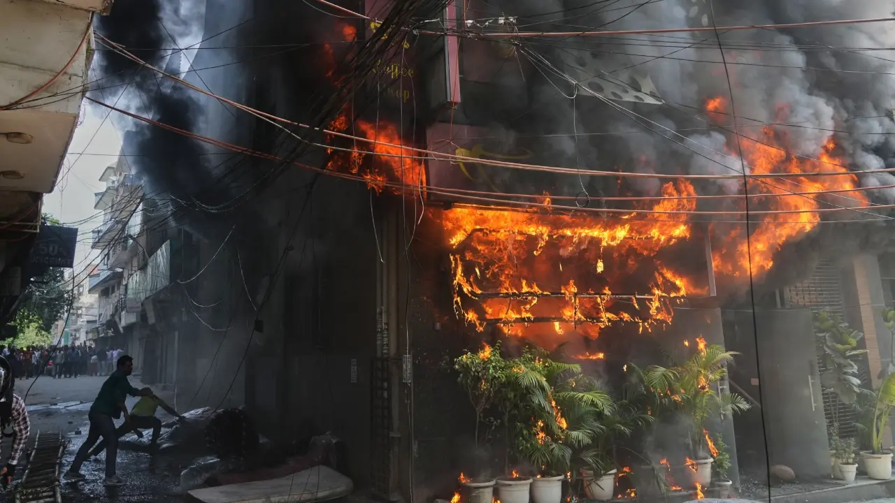 Locals attempt to douse a fire at a hotel. Pic/PTI
