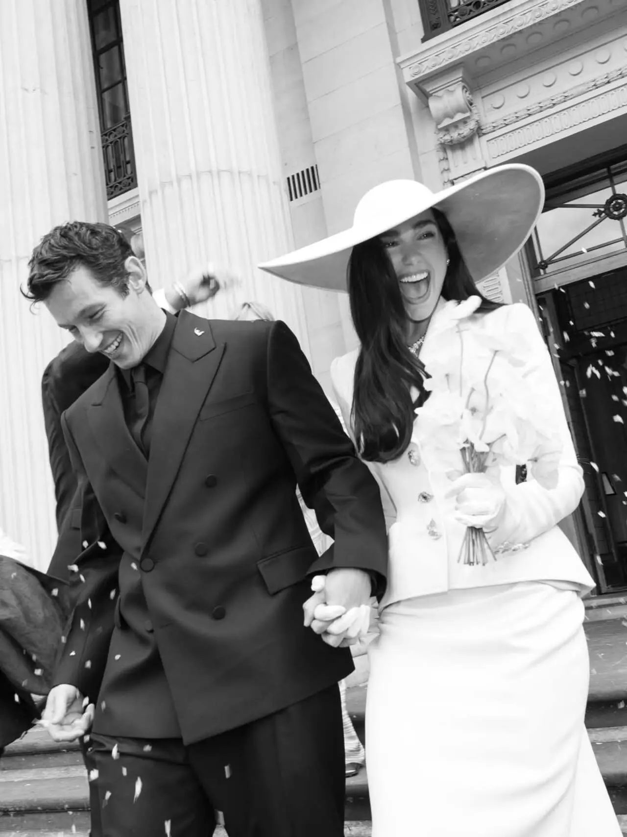 Dua Lipa
Dua Lipa outside Old Marylebone Town Hall with husband Callum Turner. She wore a custom ivory Schiaparelli suit with matching asymmetrical skirt with gold-leaf lined hat. Proof that the most stylish brides never open a bridal catalogue Dua Lipa
Dua Lipa outside Old Marylebone Town Hall with husband Callum Turner. She wore a custom ivory Schiaparelli suit with matching asymmetrical skirt with gold-leaf lined hat. Proof that the most stylish brides never open a bridal catalogue
