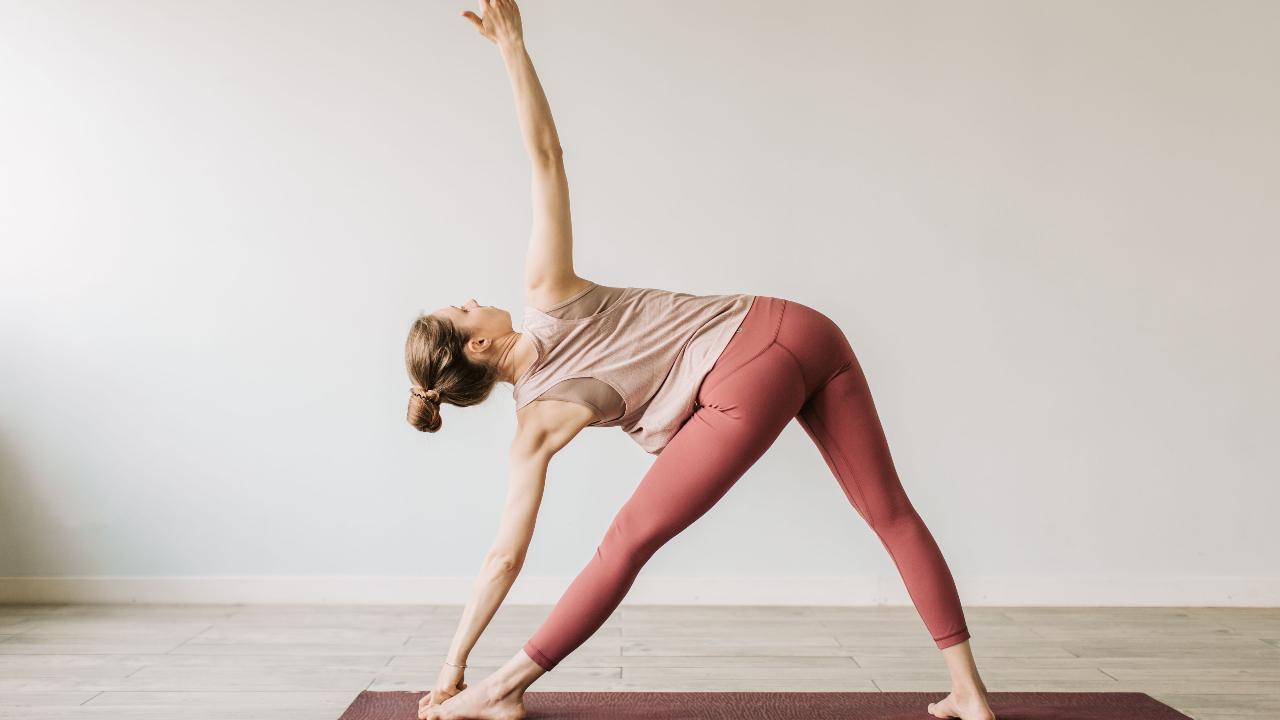 Parivrtta Trikonasana (Revolved triangle pose)&nbsp;
Revolved triangle or Parivrtta Trikonasana seems to have all but disappeared from most vinyasa flow classes. Despite being considered a fundamental asana in certain yoga systems, it can be quite challenging. Despite its challenges, it builds core strength, improves balance, stretches the hamstrings and calves, and massages abdominal organs to boost digestion and detoxification