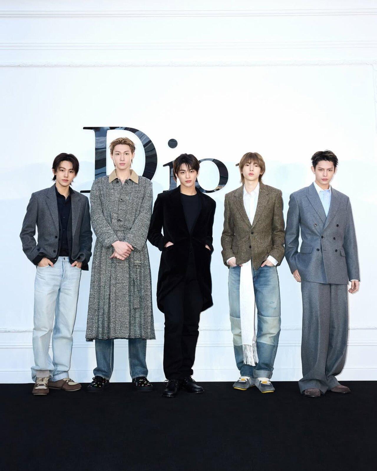 The Cortex members dazzle in a relaxed charcoal blazer with light-wash denim. A long textured coat over jeans. All-black tailored ensemble. A brown tweed blazer with wide-leg denim. And an oversized grey double-breasted suit with puddled trousers.