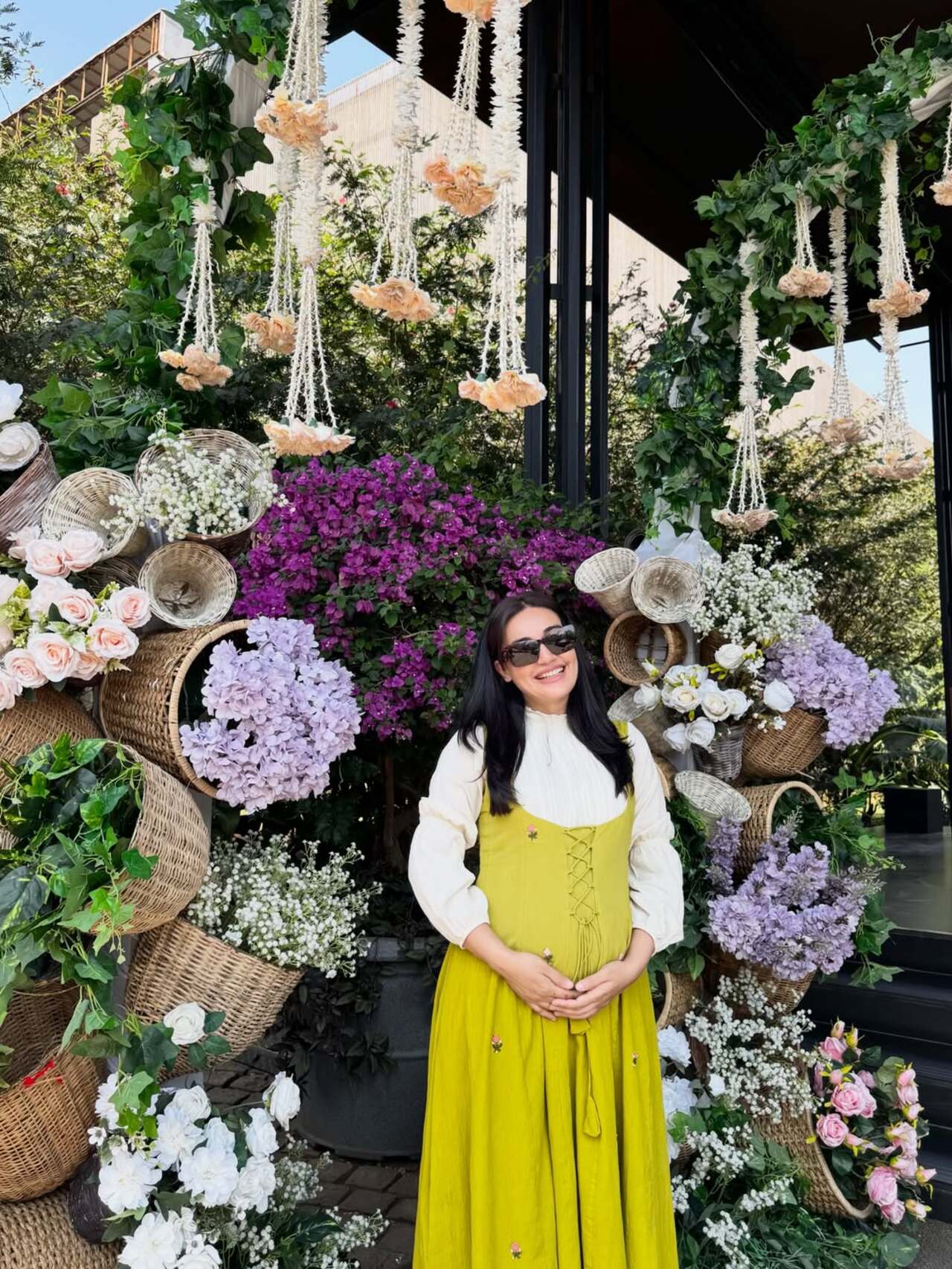 The cutie is here with all pretty flowers around her