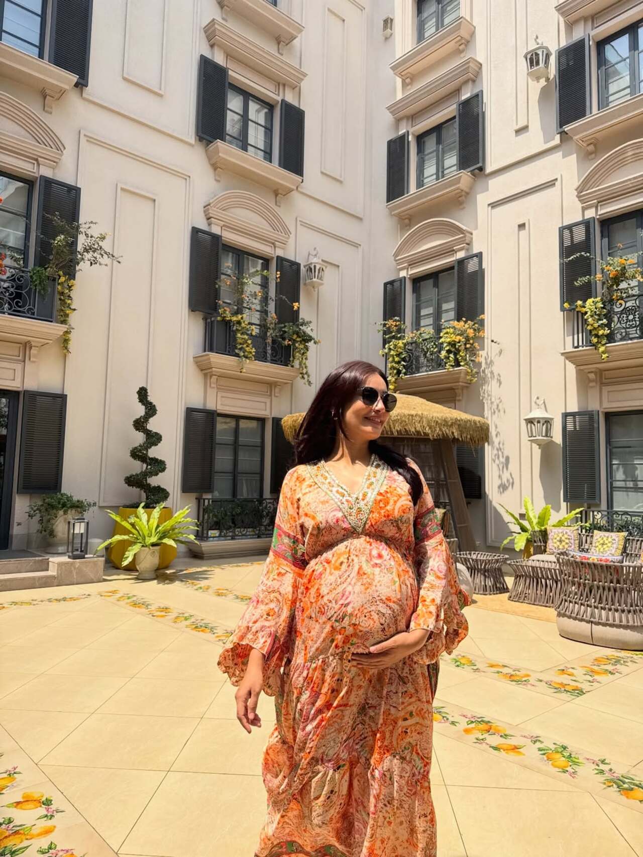 Sunshine in the cutest sunny gown, just the way she flaunts her bump