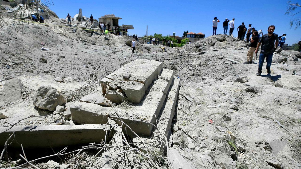 Lebanese first responders and civilians search the site of an Israeli airstrike that targeted the southern Lebanese village of Qennarit. Pic/AFP 
