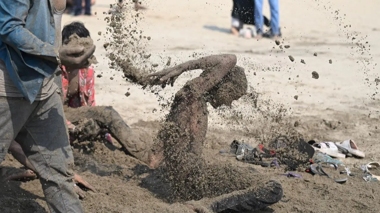 Children having a blast in the sand at chowpatty celebrating Holi