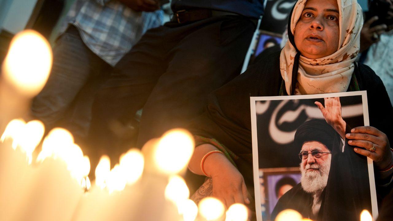A woman offers prayers for Iran's Supreme Leader Ayatollah Khamenei during condolence meeting