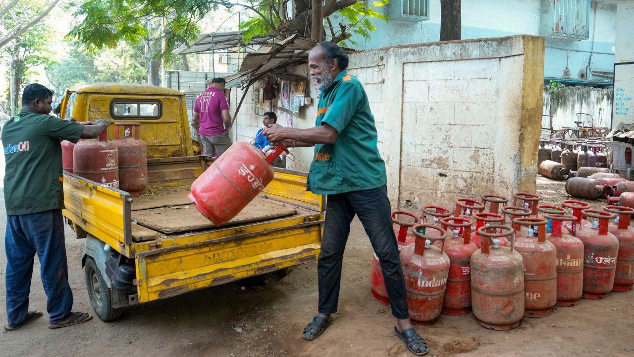 With supply running thin, a delivery person in Chennai sets out on a cycle to deliver LPG cylinders to waiting households