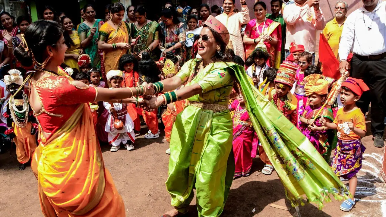 Women dressed in traditional nauvari sarees play fugdi during a Gudi Padwa procession in Mumbai