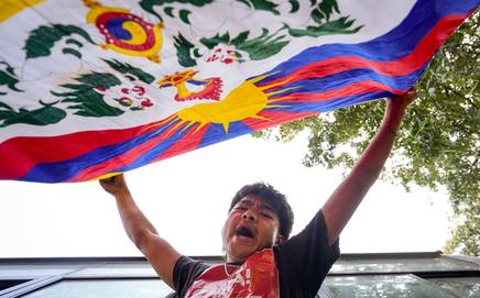 A Tibetan Youth Congress member waves the Tibetan national flag during a demonstration marking the '67th National Uprising Day'. Pic/PTI