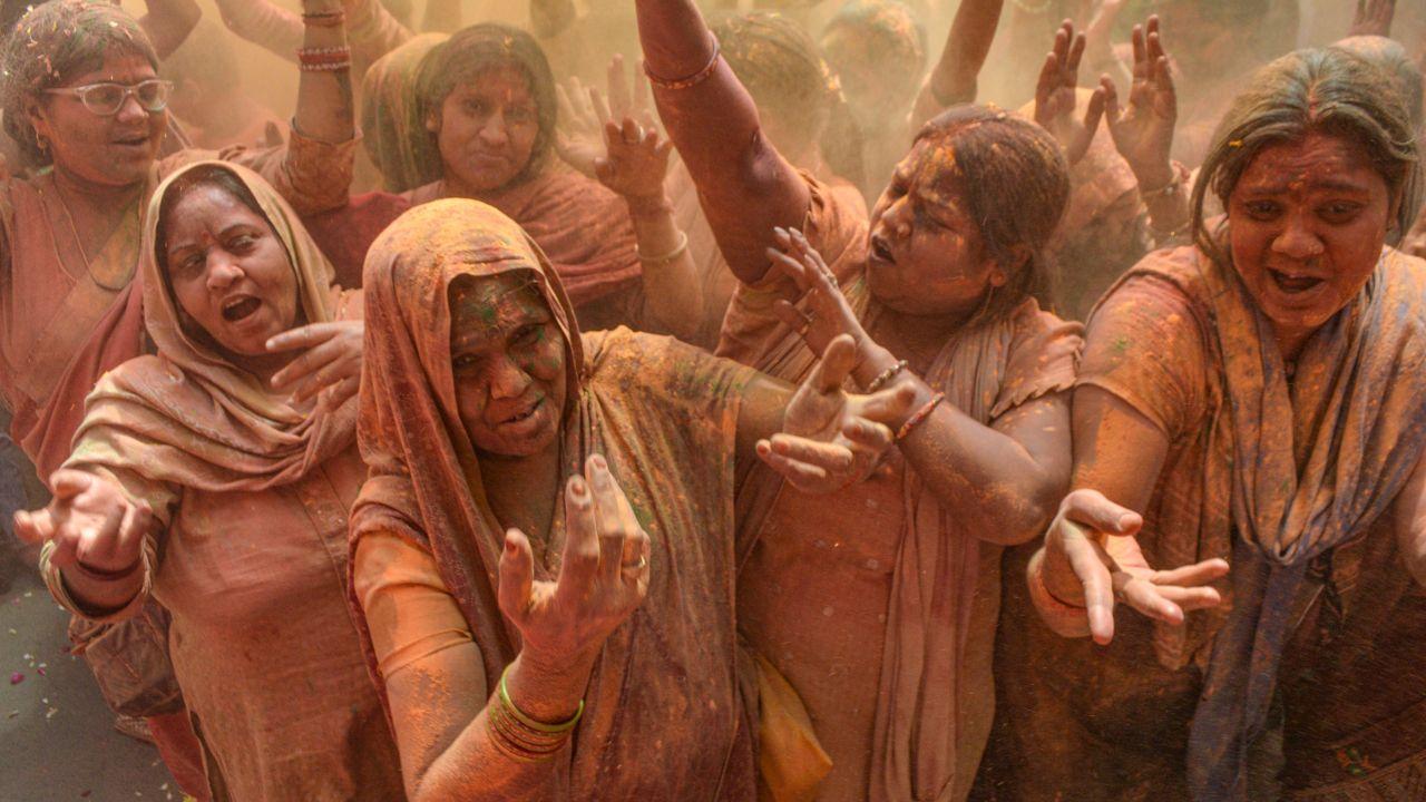 Revellers smear bright powders on each other, spreading happiness and festive cheer