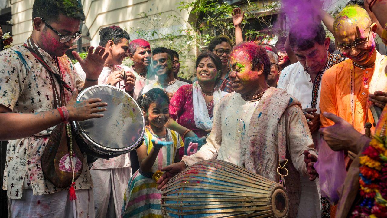 A riot of colours fills the sky as people celebrate Holi with music, dance and laughter
