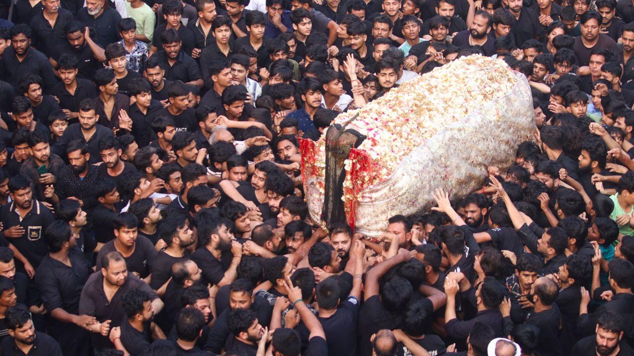 Devotees take part in the Shabih-e-Taboot Gileem procession that began from Masjid-e-Kufa, commemorating the life and sacrifice of the first Shia Imam