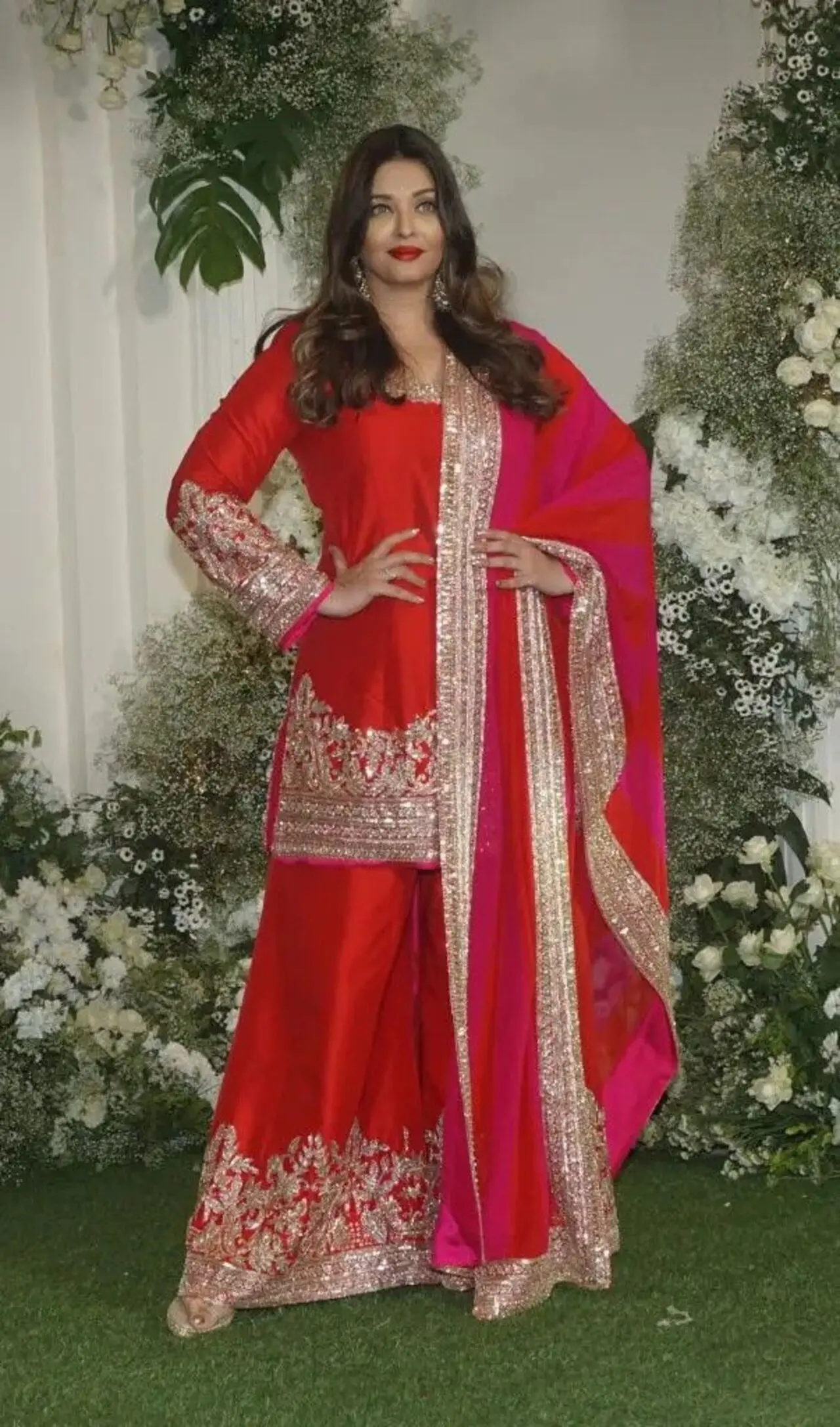 Make heads turn like Aishwarya Rai Bachchan in this red sharara set, which has intricate gold embroidery on the kurta and hem of the palazzo pants, paired with a matching dupatta. 