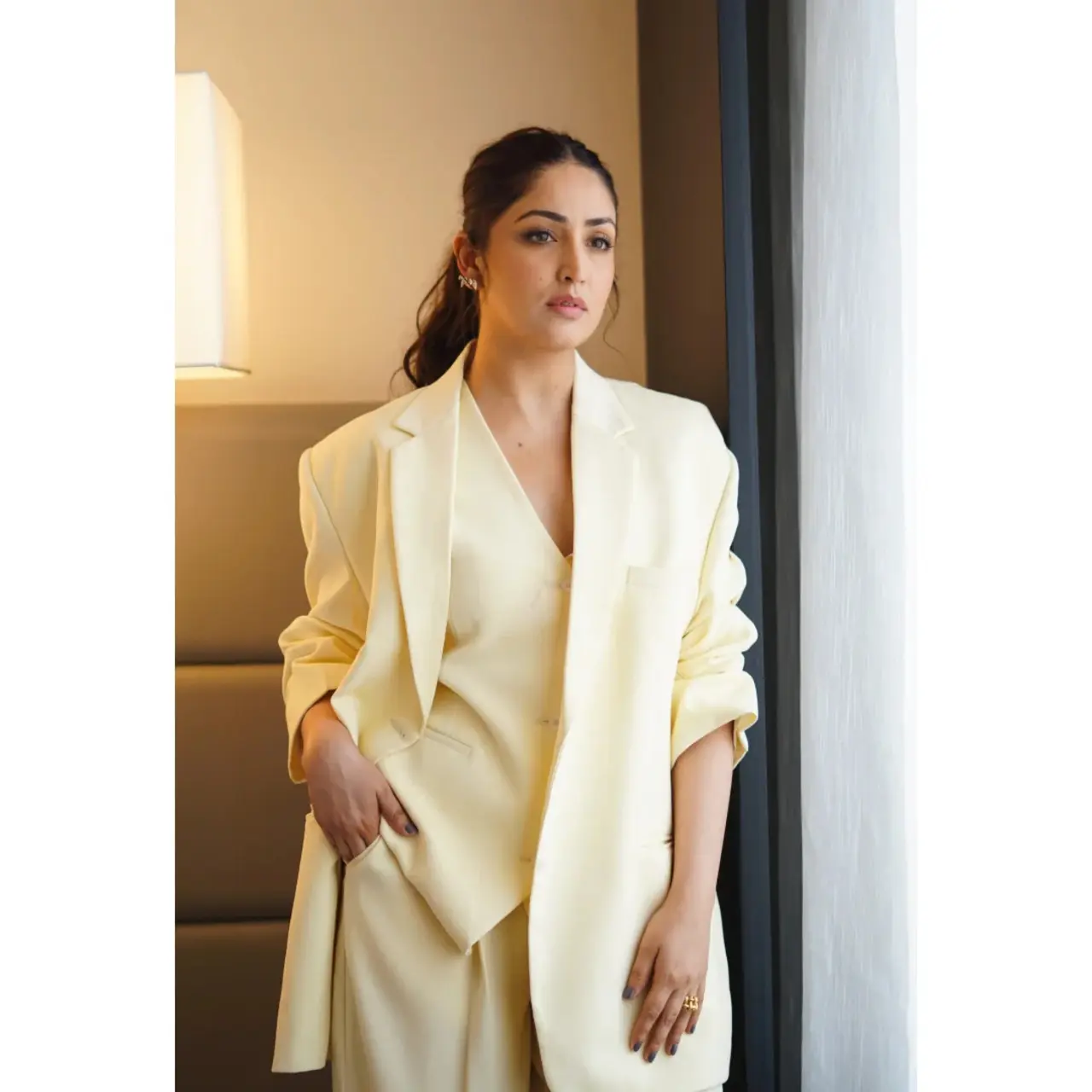 Yami brings a refreshing softness to power dressing in an oversized butter yellow suit. The relaxed fit blazer and coordinated trousers create an effortlessly chic ensemble, that's both approachable and authoritative.
