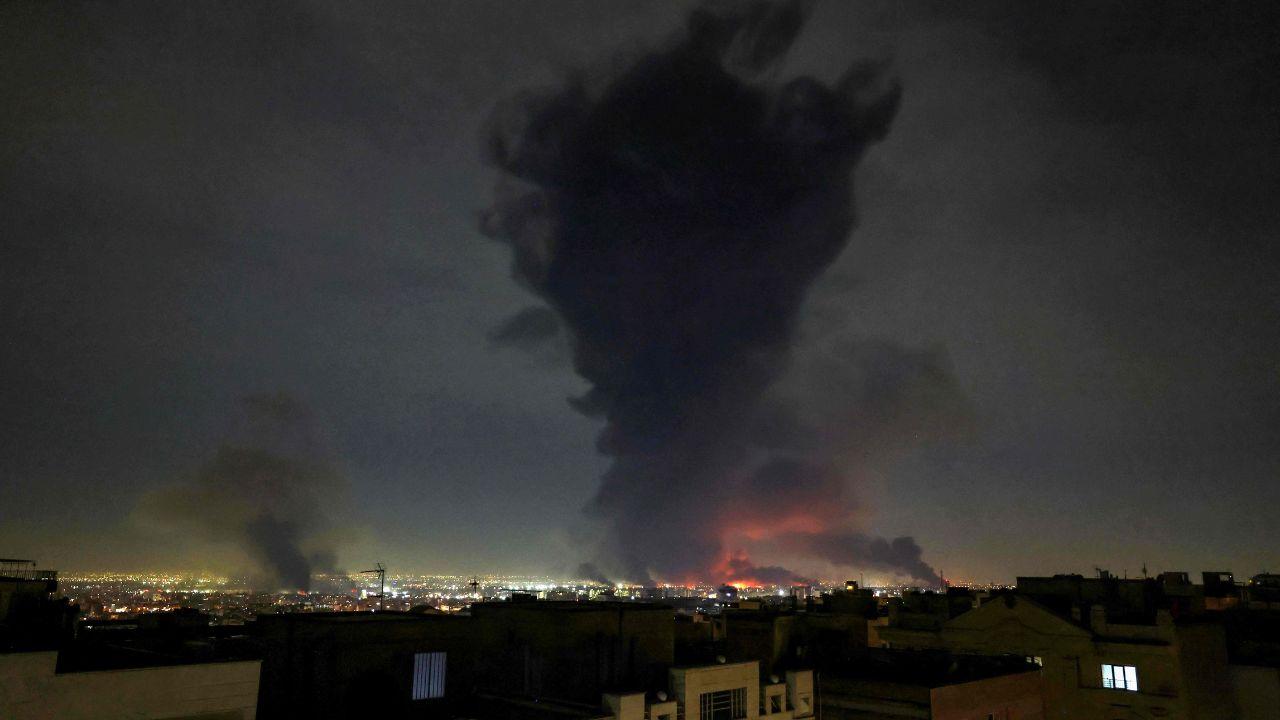 Smoke rises from the site of airstrikes at Mehrabad International Airport as the conflict triggers global economic concerns, especially around energy supply