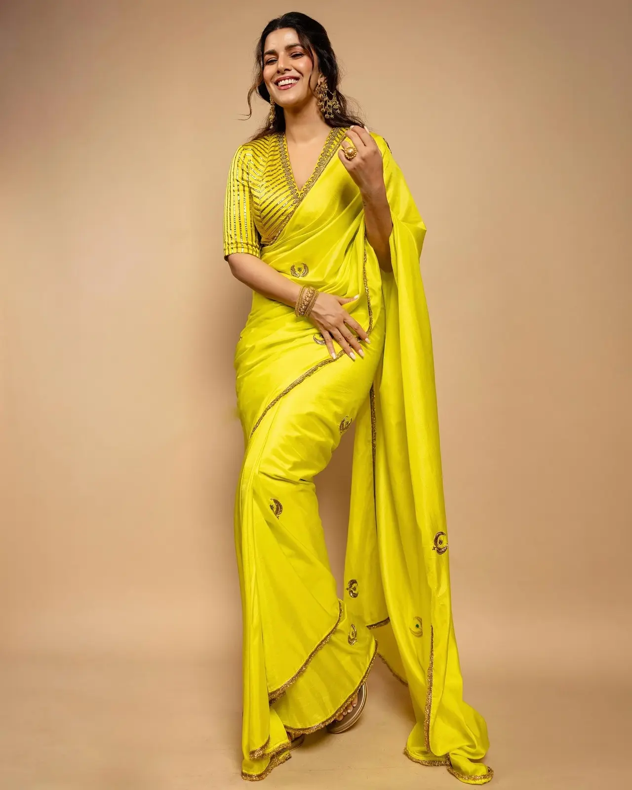 Nimrat Kaur dazzled in a sunny yellow saree, featuring delicate chand motifs on the pallu. She paired it with a chic V-neck blouse, creating a bright, elegant look that’s both contemporary and effortlessly graceful.