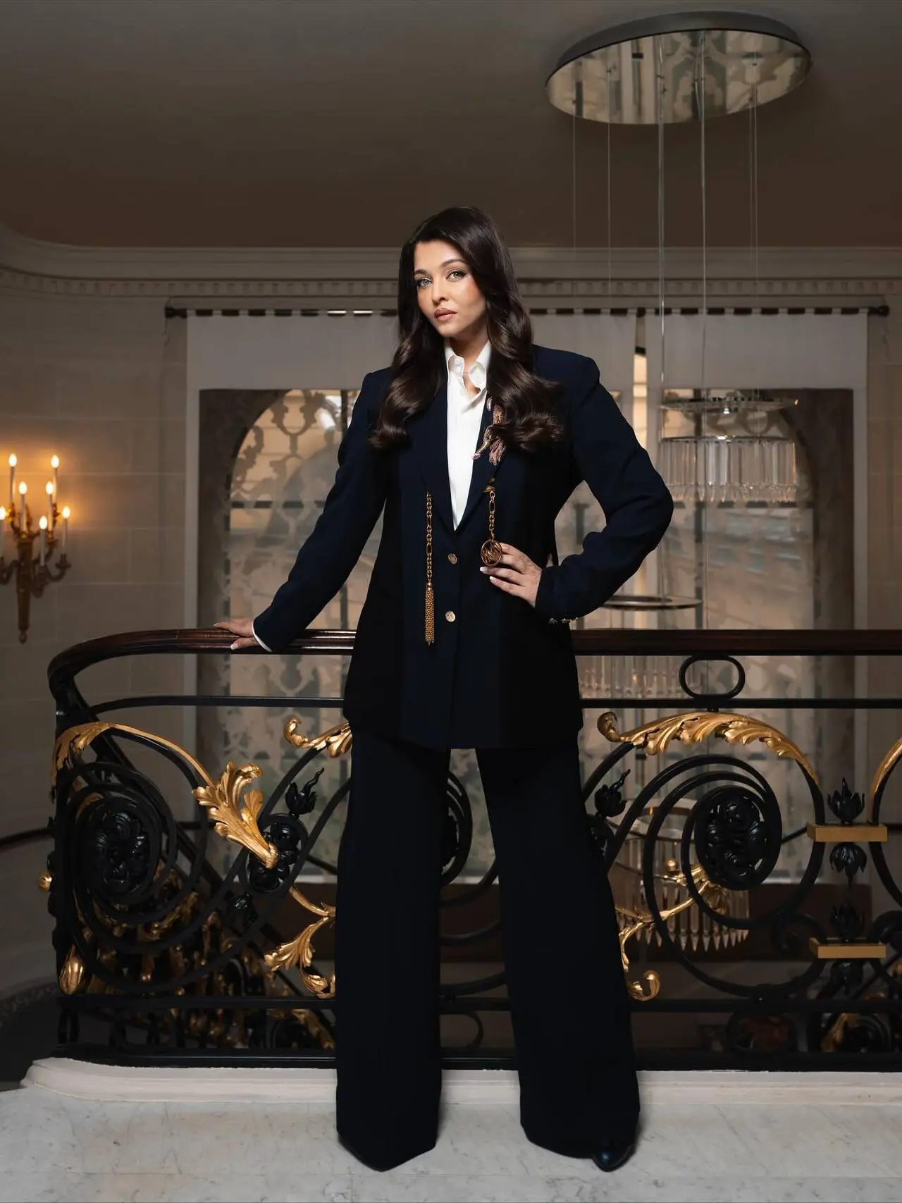 Aishwarya channels timeless sophistication in a navy blue double-breasted suit, paired with a crisp white shirt. This look of Ash, embodies corporate elegance with a regal twist, proving that the classics never go out of style.