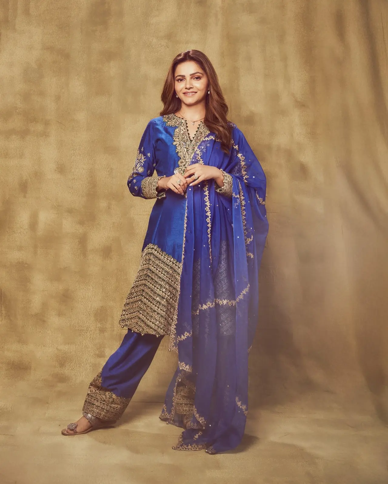 <p>Rubina Dilaik stuns in a dark blue suit featuring intricate gold work below the sharara, paired with a flowing net dupatta.</p> <p>Rubina Dilaik stuns in a dark blue suit featuring intricate gold work below the sharara, paired with a flowing net dupatta.</p>