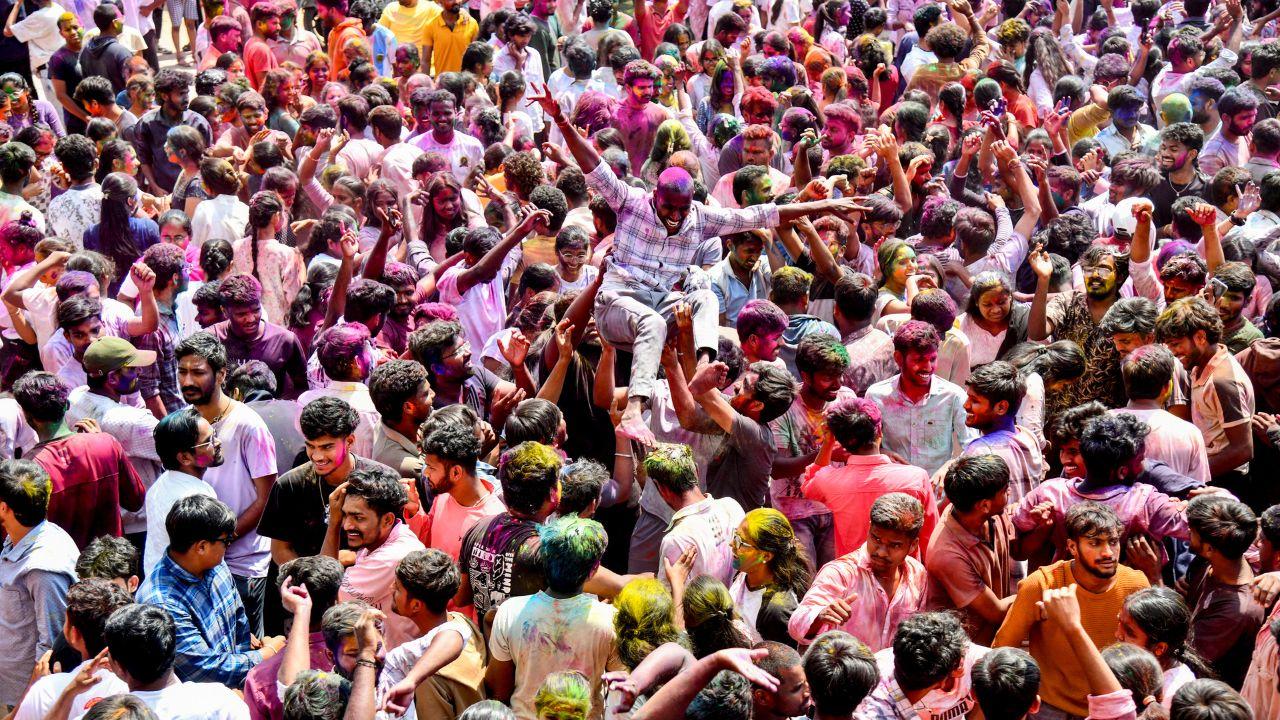 Students smeared in 'gulal' during celebrations of the 'Holi' festival, in Hyderabad